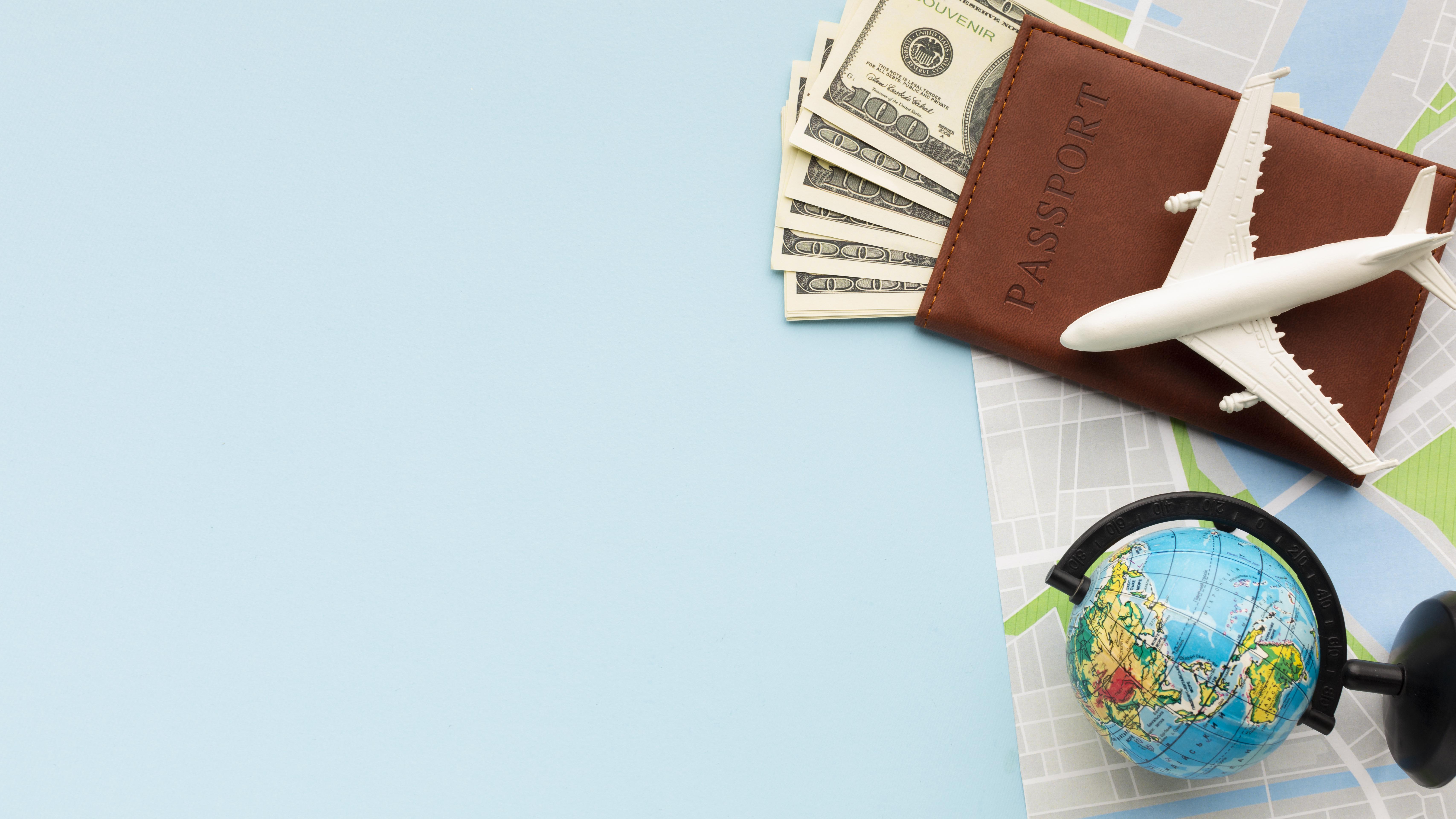 a wallet with money, an airplane and a globe